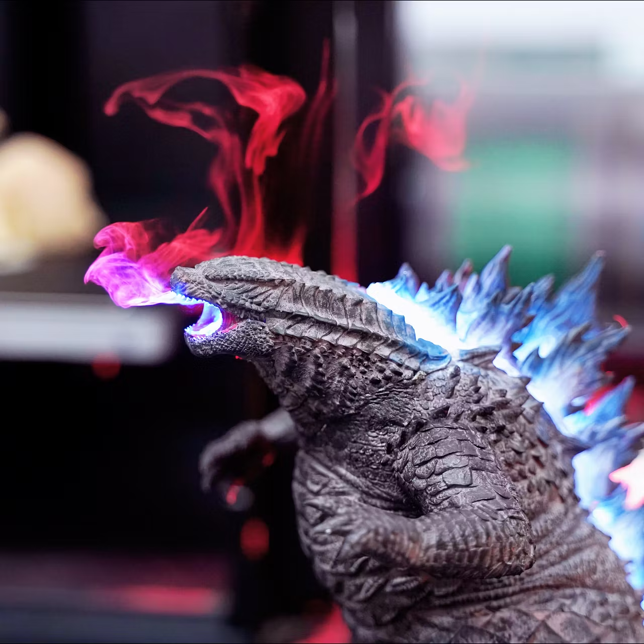 Mistzilla atomic breath humidifier firing glowing mist plume, dorsal fins lit